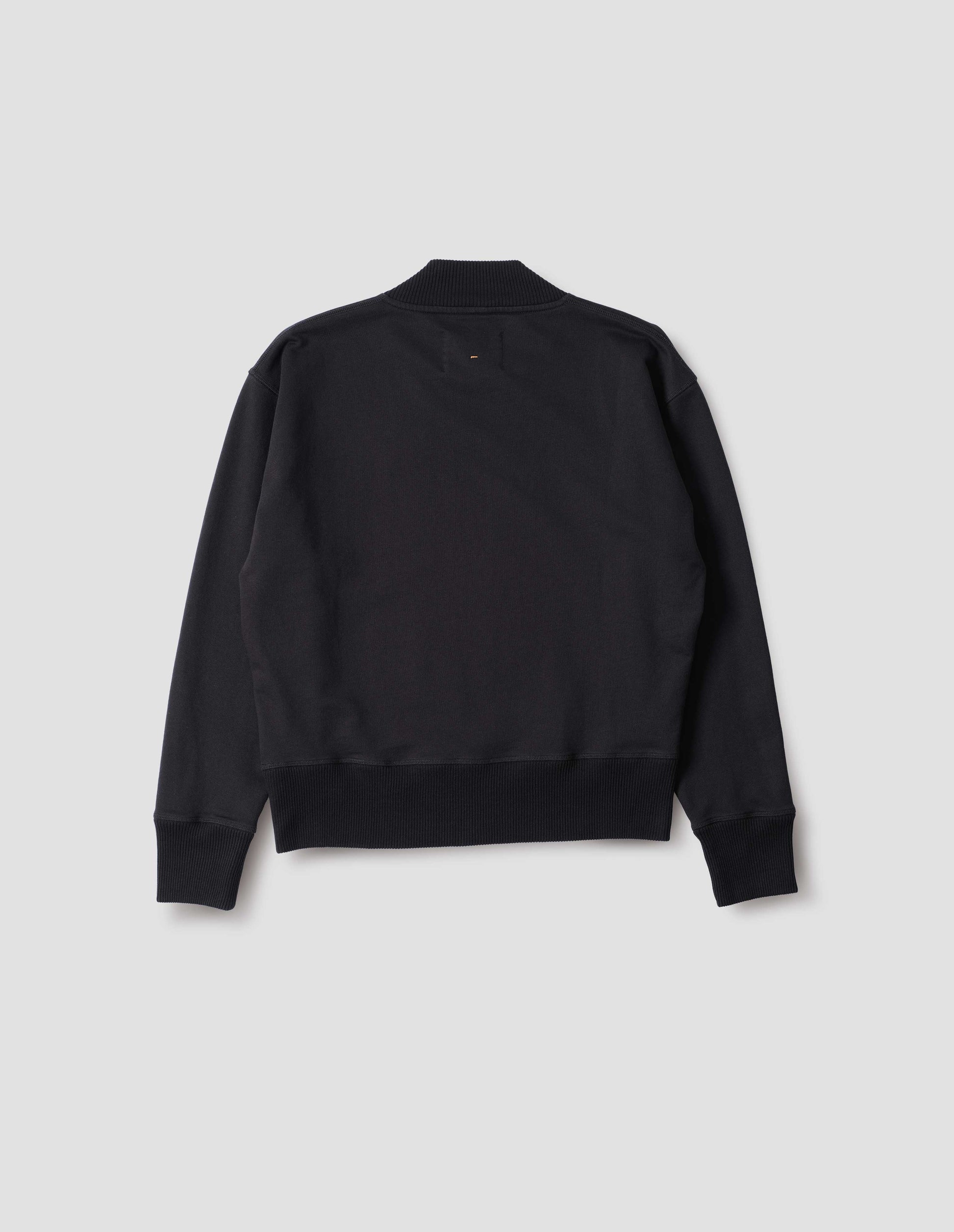 Black cotton sweatshirt, with ribbed neck, cuffs and hem. Back flat lay view.