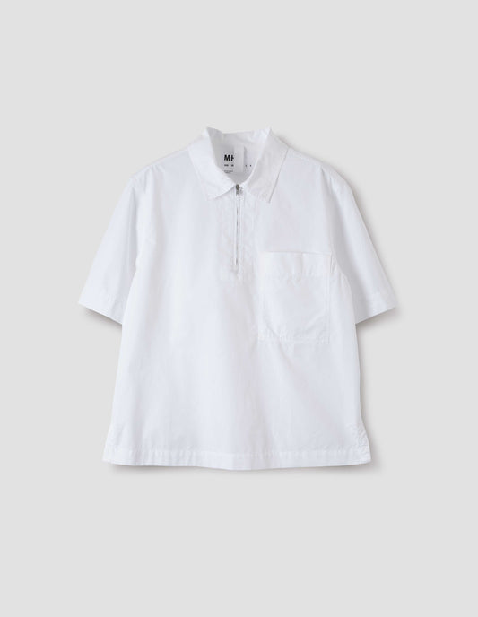 White short-sleeved shirt with wide stitch-through placket with half zip, patch chest pocket and side split hem. Front flat lay view.