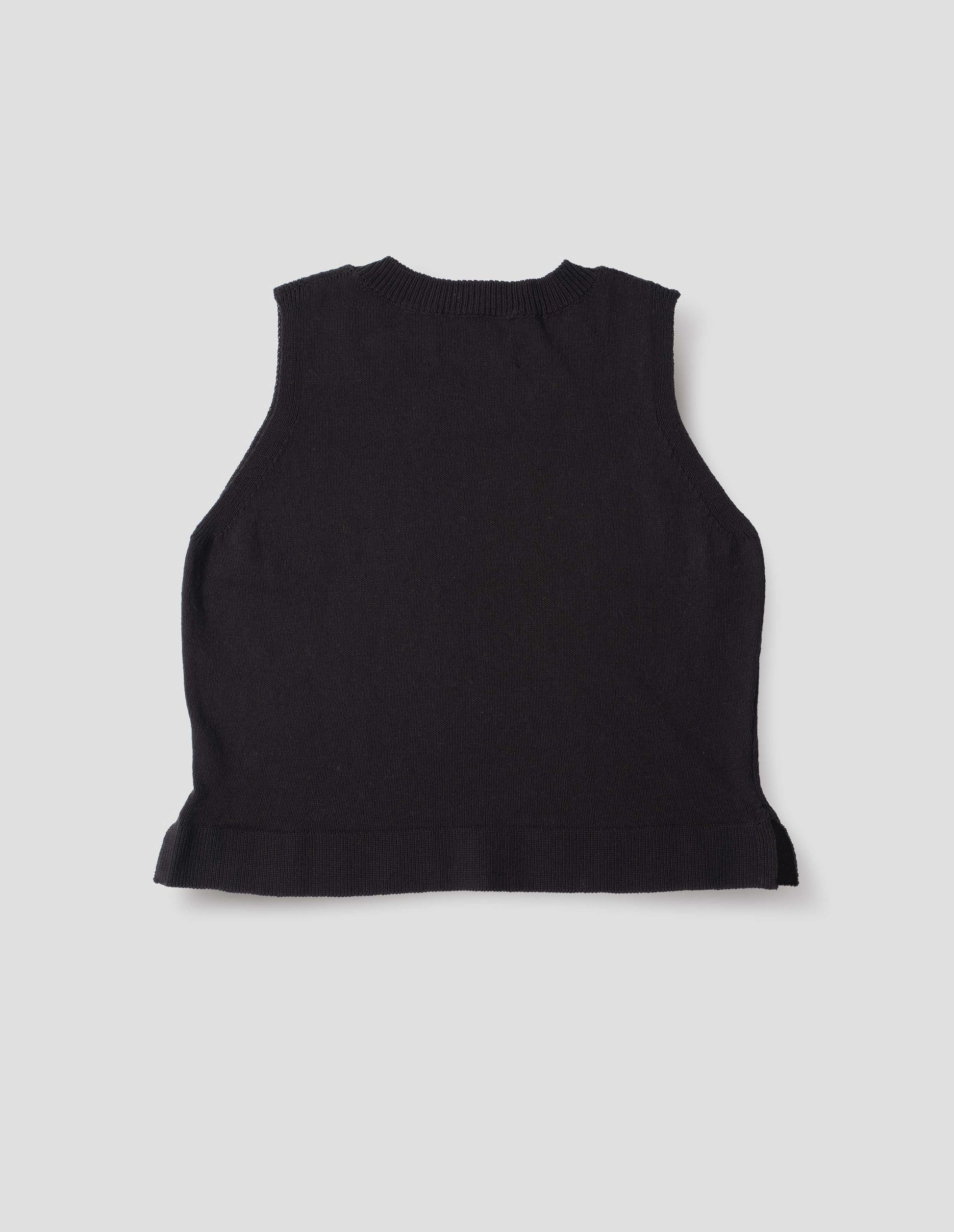 Black knitted tank top with single rib crew neck and side split rib hem. Back flat lay view.