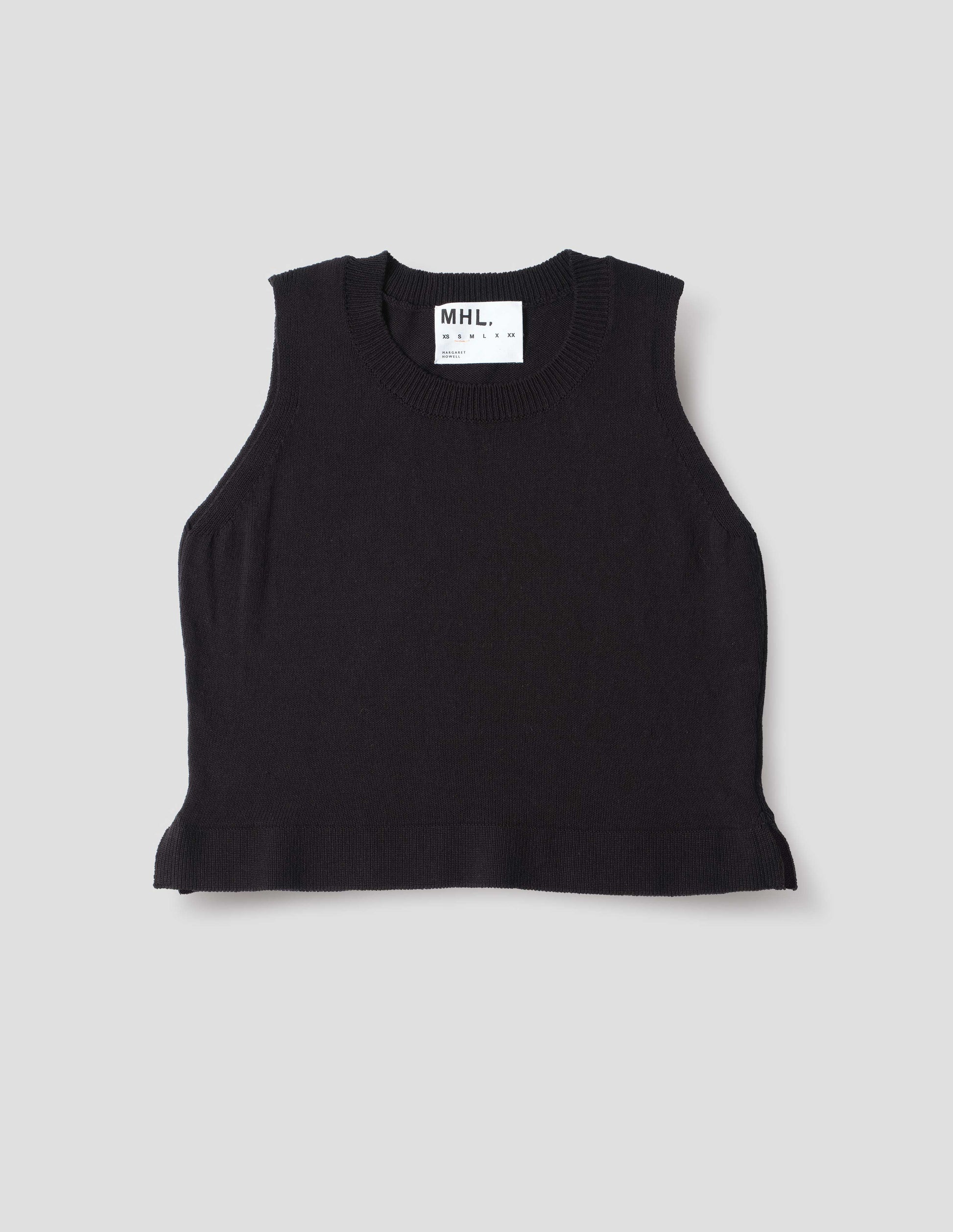Black knitted tank top with single rib crew neck and side split rib hem. Front flat lay view.