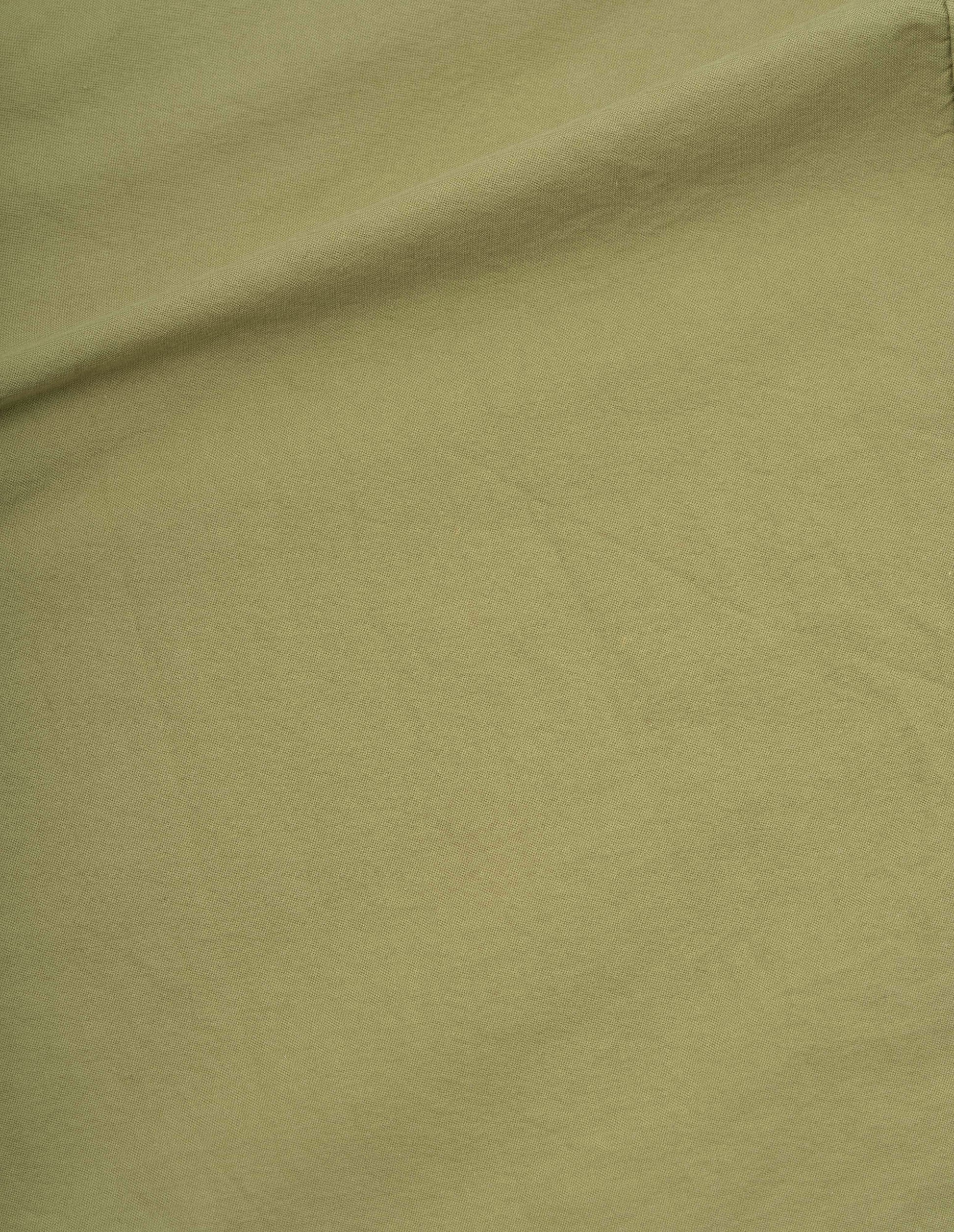 Yellowish green cotton canvas shirting shirt, fabric swatch.