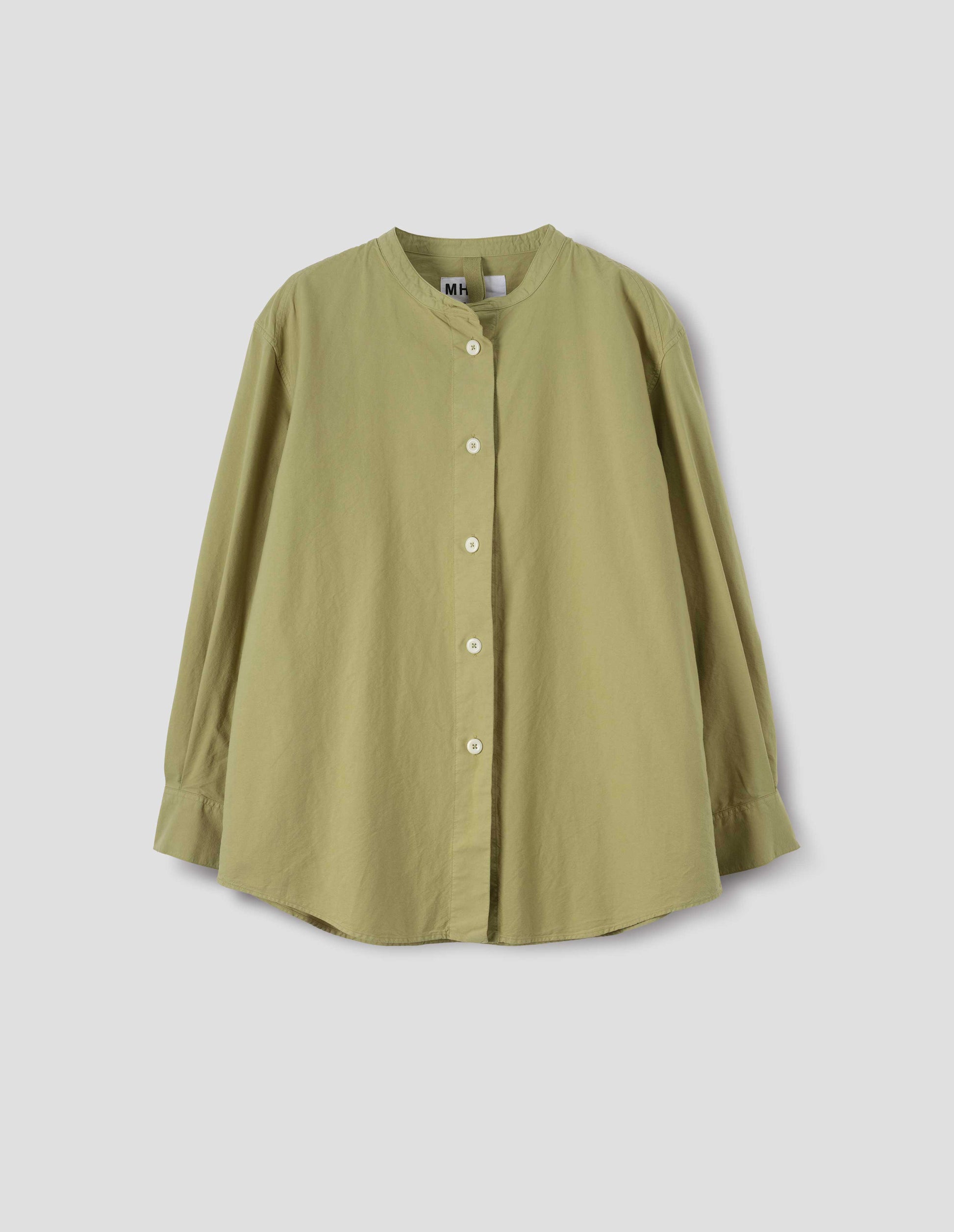 Yellowish green cotton canvas long sleeve collarless shirt. With wide stitch through placket, corozo brace buttons and double button fastening cuffs. Front flat lay view.