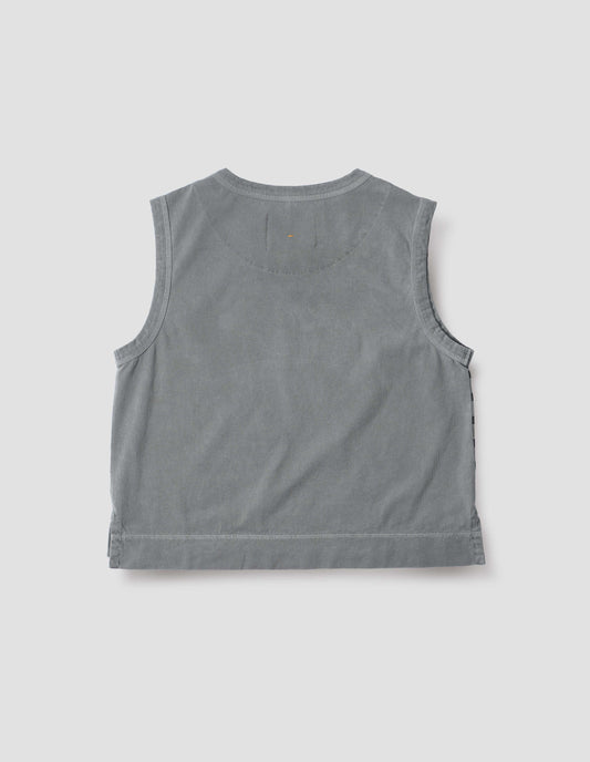 Blue cotton linen tank top with contrast ribbing on neckline and armholes, with stitch-through half moon on back yoke, side splits and deep stitch hem. Back flat lay view.