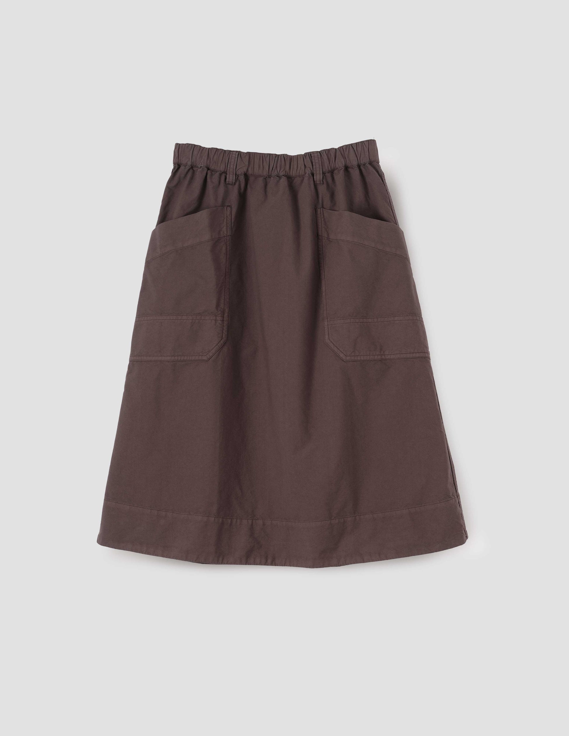 Brown cotton skirt with large slant patch pockets, elasticated waistband with belt loops and deep stitch hem. Front flat lay view. 