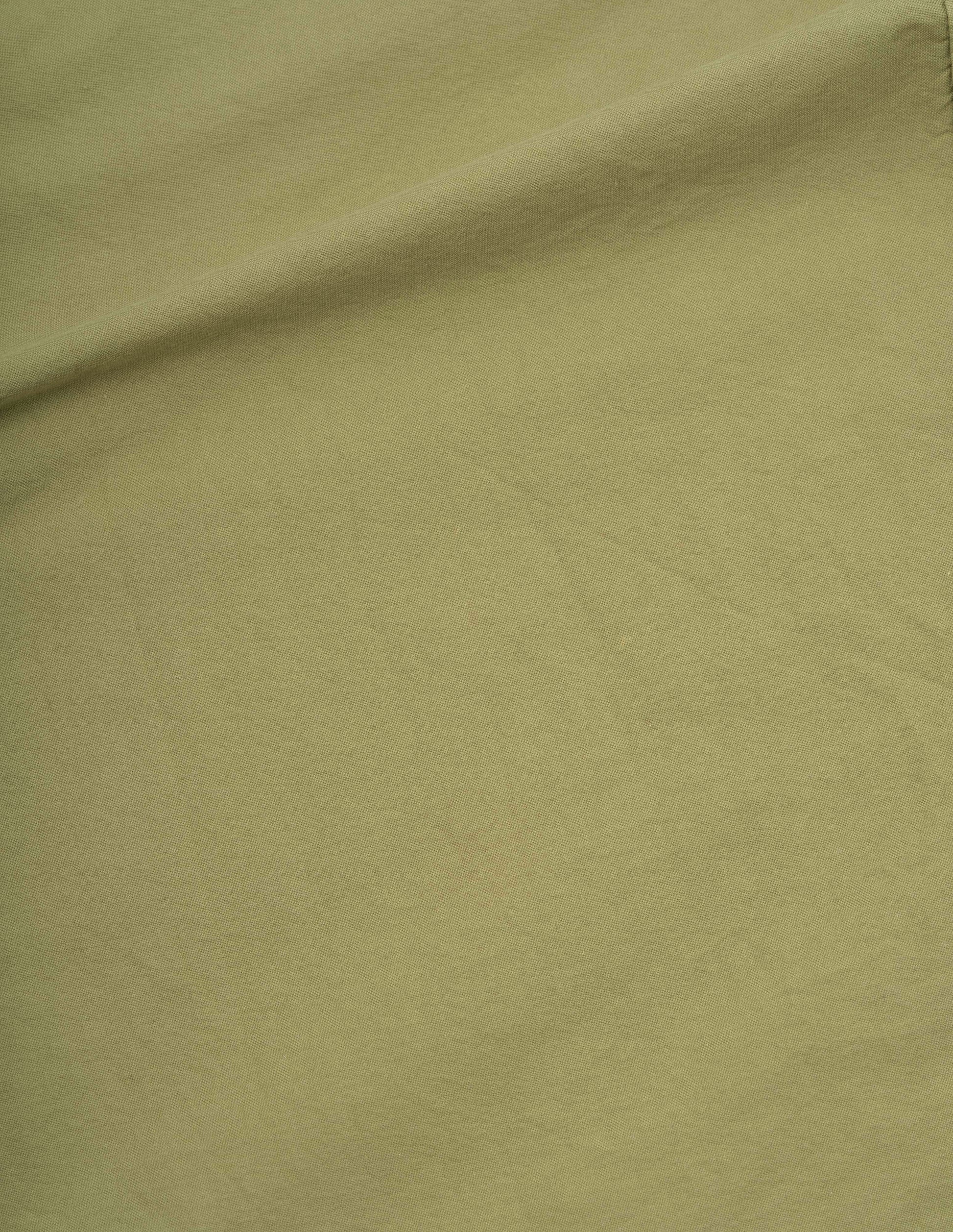 Light green cotton canvas shirting skirt fabric swatch.