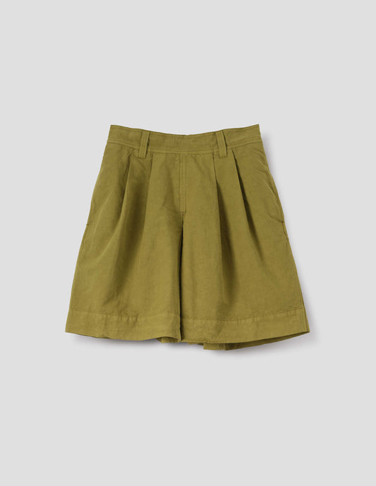 Yellowish green cotton linen shorts with pleated skirt front panel, semi-elasticated waistband, side pockets, and belt loops. Front flat lay view.