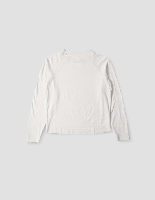 White cotton linen long sleeve t-shirt with contrast rib on neckline and raglan sleeve detailing. Front flat lay view.