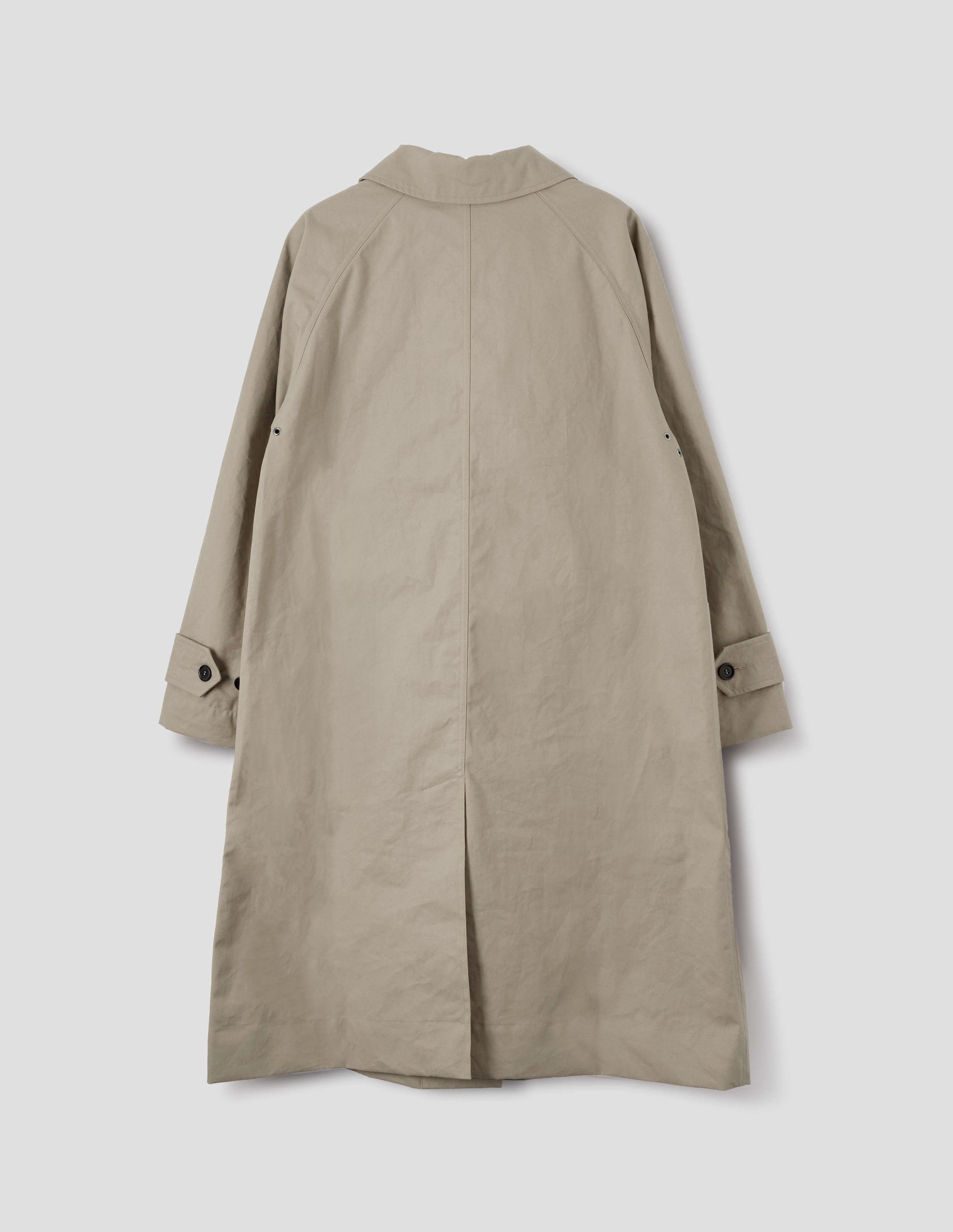 Beige cotton canvas long sleeve mac, with button tab adjustable cuffs and rear vent. Back flat lay view.