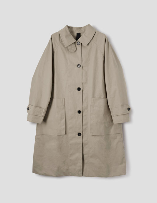 Beige cotton canvas long sleeve mac, with storm tab fastening neck, raglan sleeve, button tab adjustable cuffs and large patch bellow pockets. Front flat lay view.