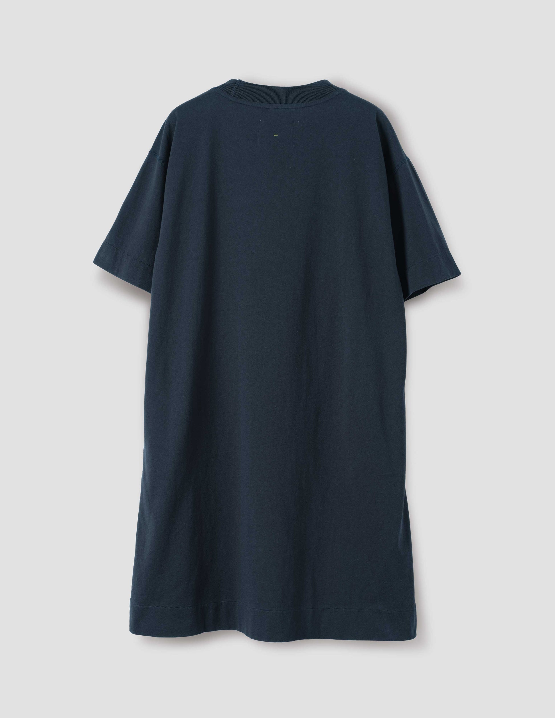 Dark navy blue short sleeve cotton t-shirt dress. With concealed side pockets, seam detailing, side split hems and flatlock stitch seam detailing. Back flat lay view.