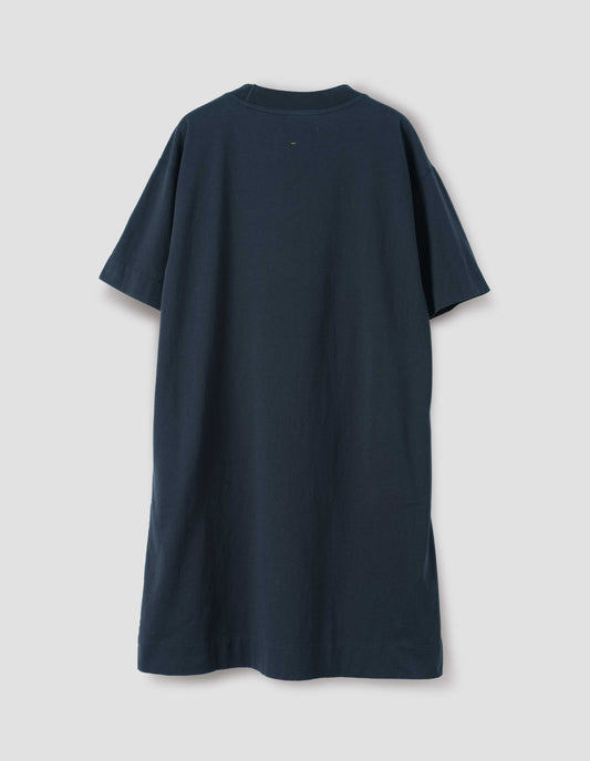 Dark navy blue short sleeve cotton t-shirt dress. With concealed side pockets, seam detailing, side split hems and flatlock stitch seam detailing. Back flat lay view.