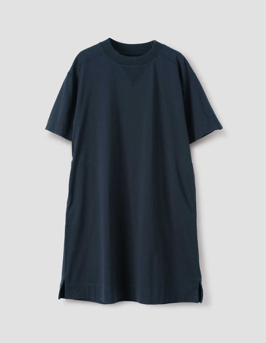 Dark navy blue short sleeve cotton t-shirt dress. With concealed side pockets, seam detailing, side split hems and flatlock stitch seam detailing. Front flat lay view.