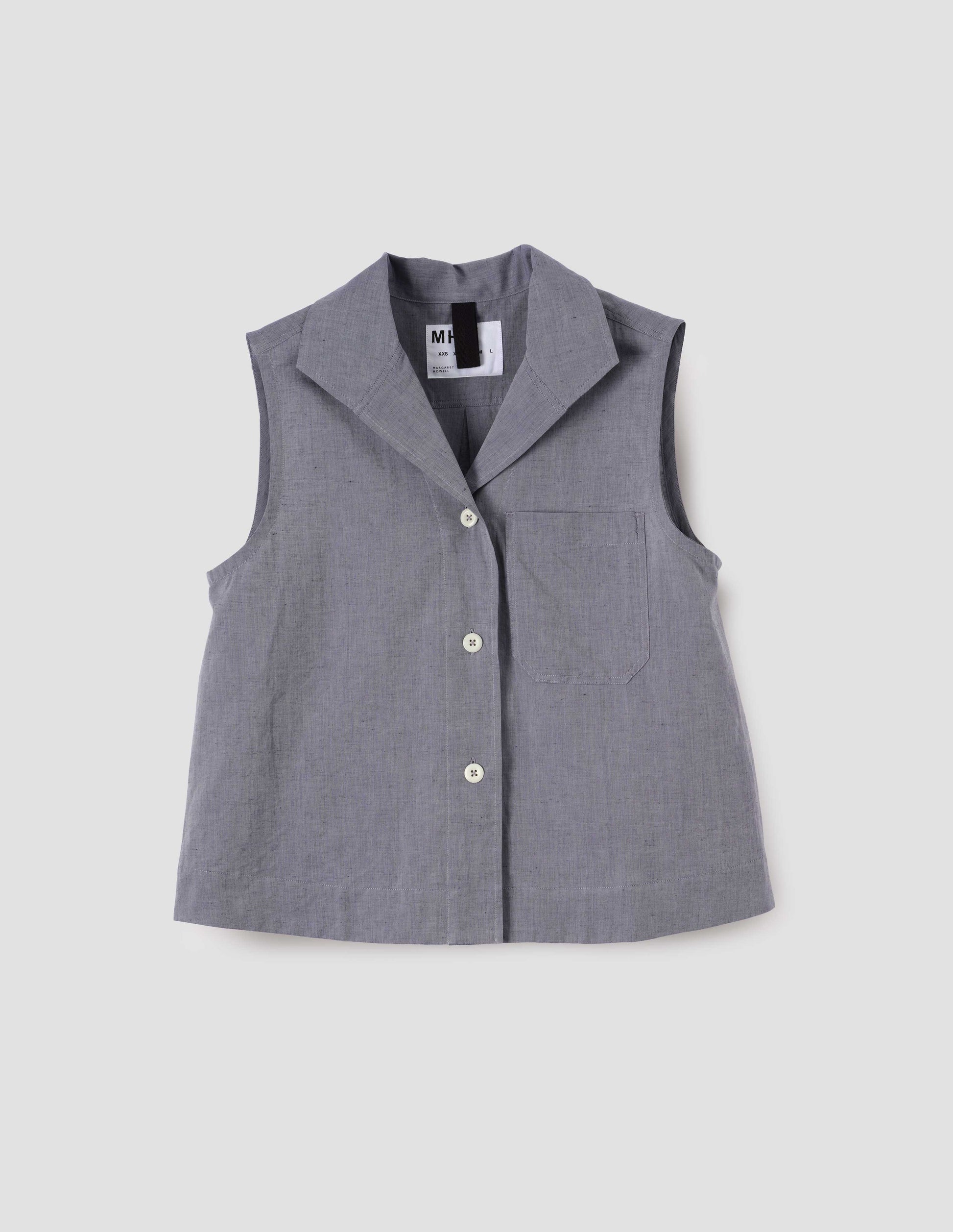 Blueish grey cotton sleeveless shirt with a box pleat and hanger loop detail on back yoke. Back flat lay view.
