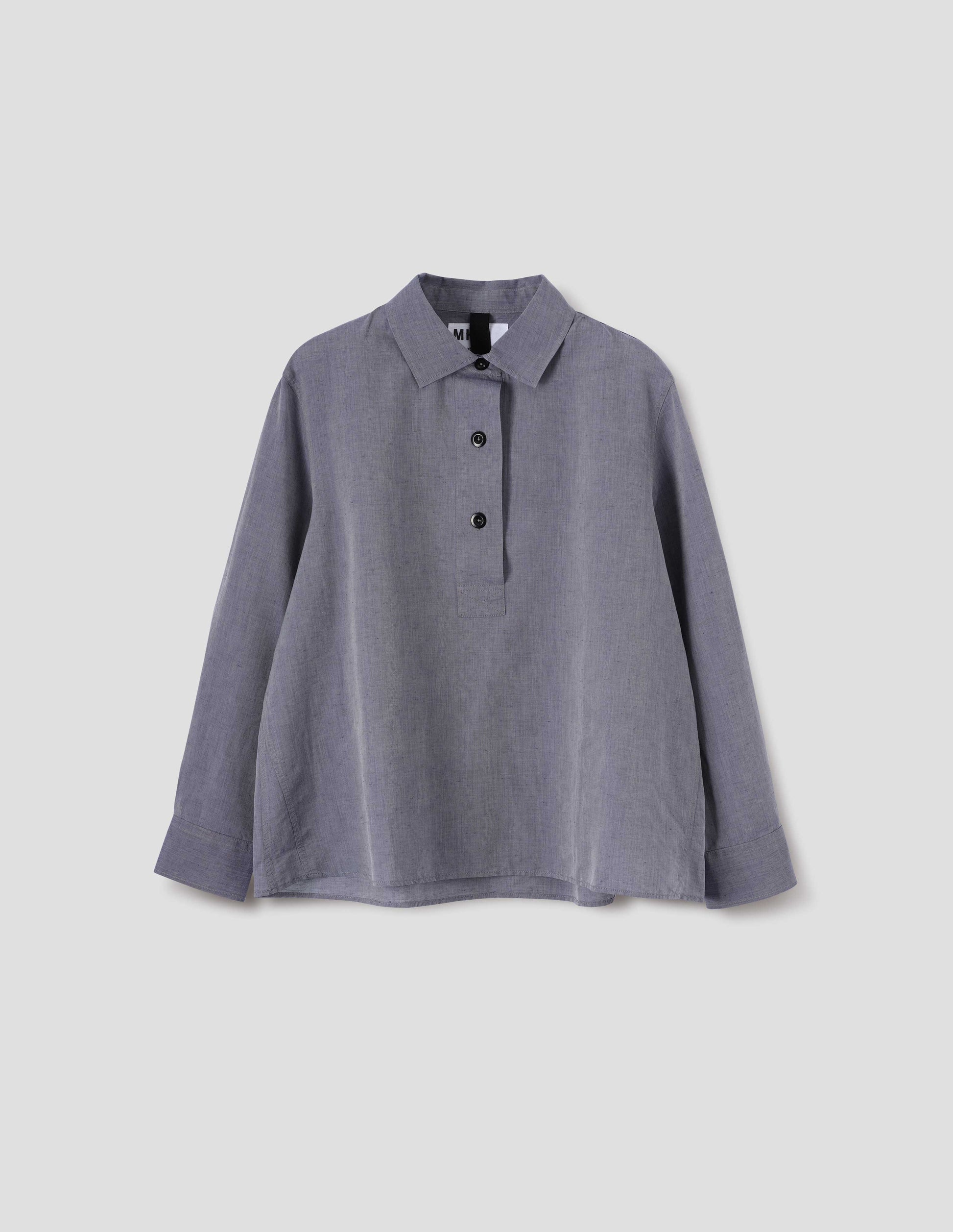 Greyish blue long sleeve cotton linen shirt, with half raised placket, side gusset stitching and corozo brace buttons. Front flat lay view.