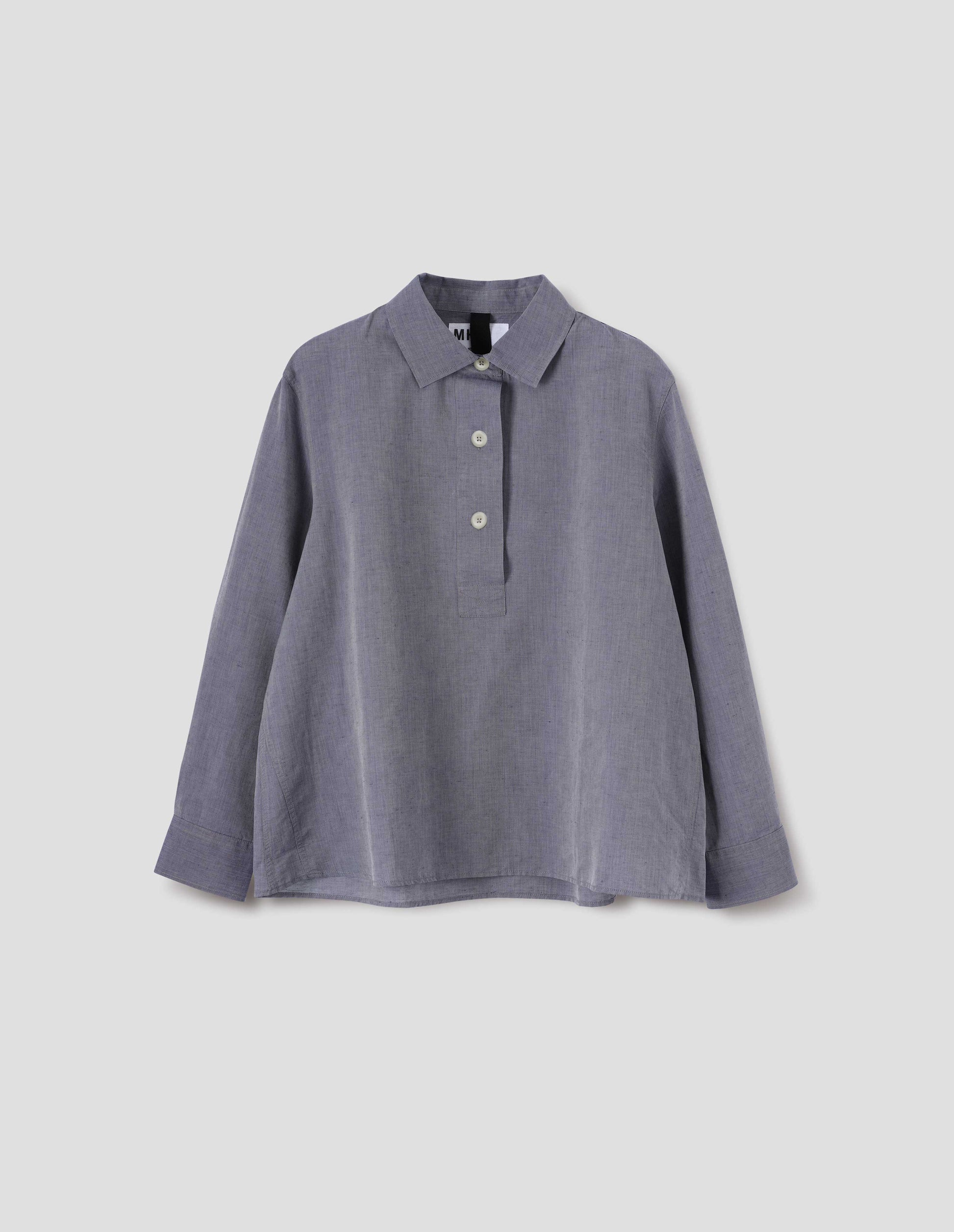 Greyish blue long sleeve cotton linen shirt, with half raised placket, side gusset stitching and corozo brace buttons. Front flat lay view.