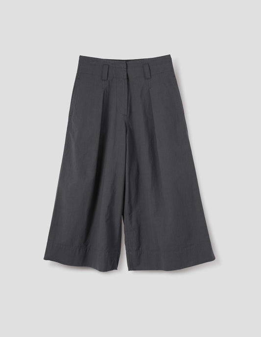 Grey culottes with zip fly, stitch-through waistband with dropped belt loops, bar tacked pleats, concealed wide pockets and deep stitch-through hem. Front flat lay view.