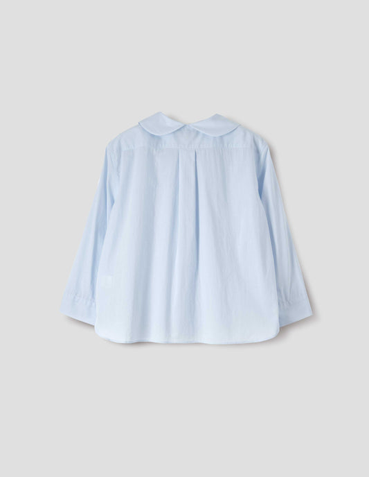 Light blue cotton shirt, with round petal collar, box pleats on back yoke, three quarter sleeves with turned back cuff detail. Back flat lay view.
