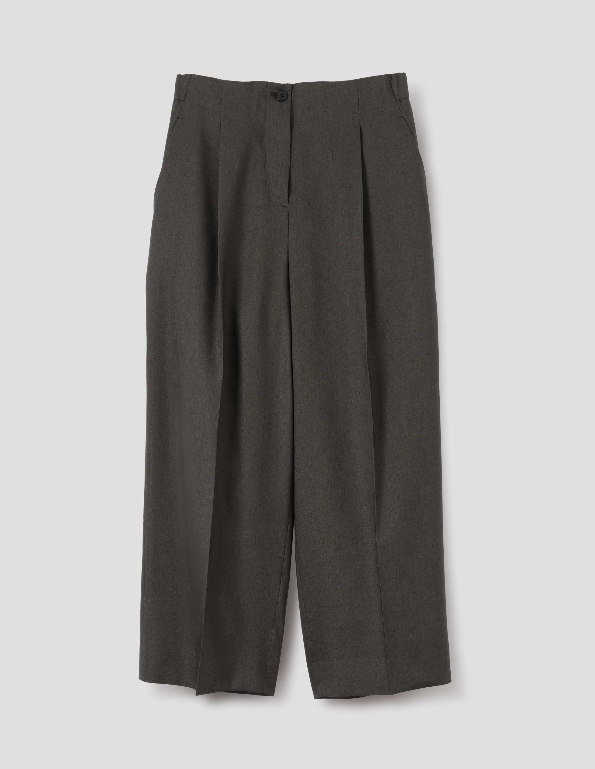 Brownish green linen silk trousers, with horn button fastening, single pleats and slant side pockets. Front flat lay view.