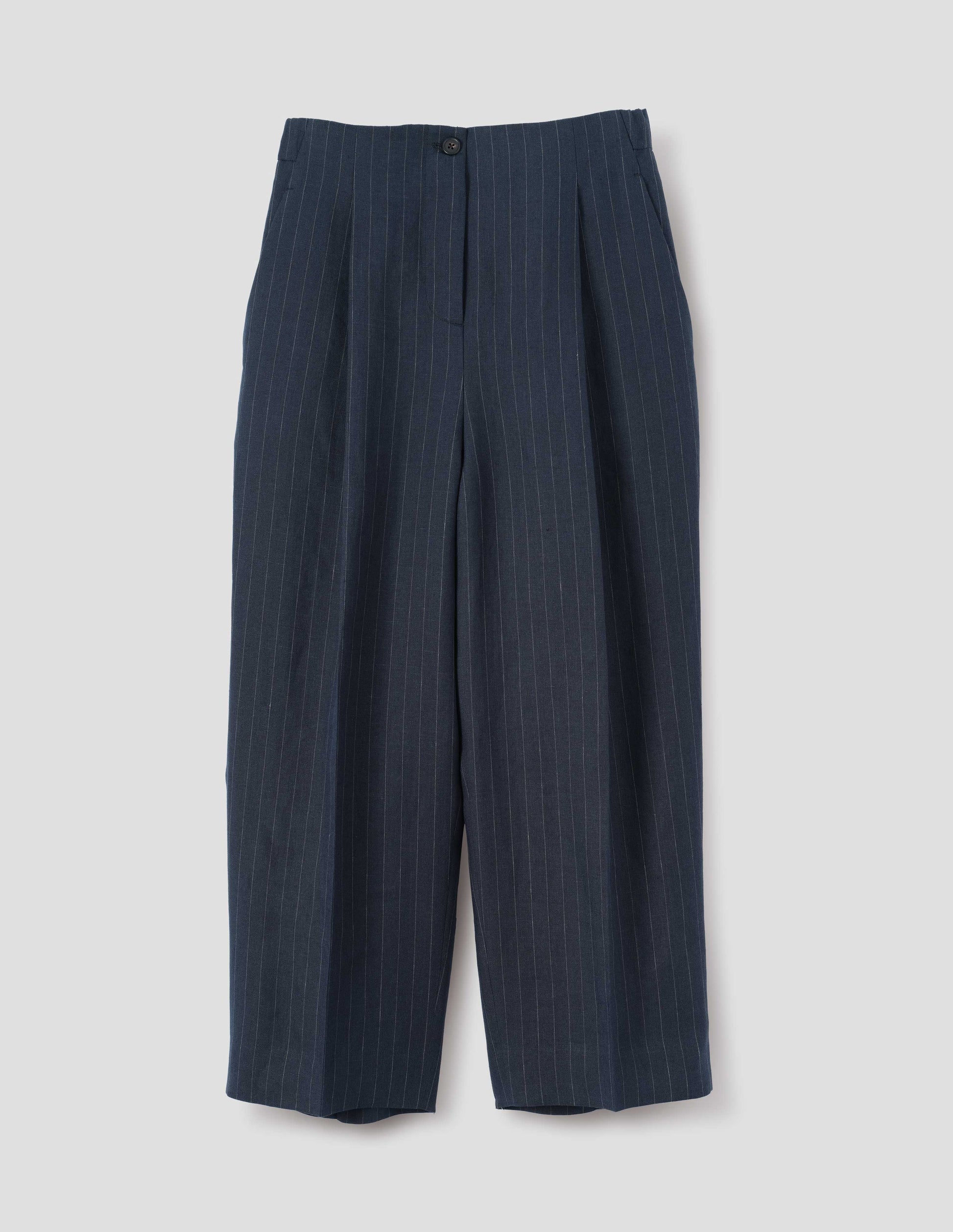Dark navy and grey pinstripe linen trousers, with horn button fastening, single pleats and slant side pockets. Front flat lay view.
