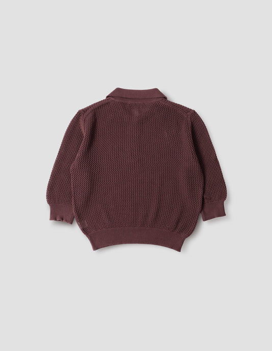 Brownish red cotton cashmere pointelle polo shirt, with solid seam detailing, rib collar, placket, cuffs and hem. Back flat lay view.