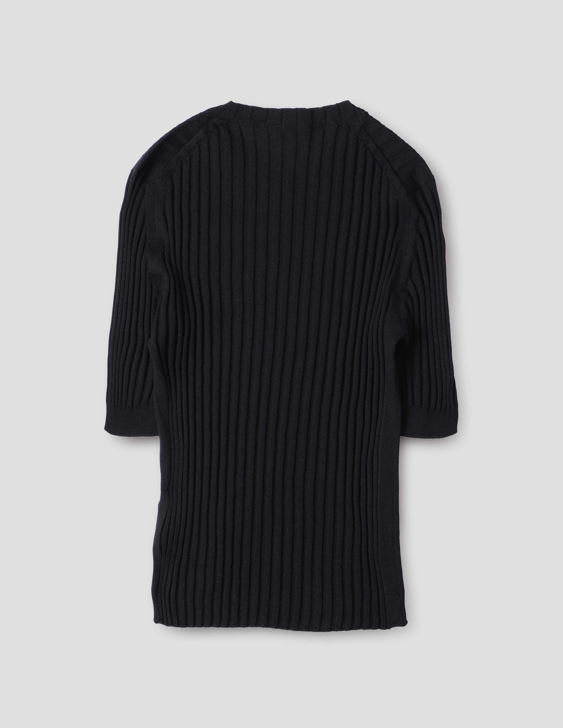 Black knitted ribbed t-shirt with round neck and fine rib sleeve cuffs. Back flat lay view.
