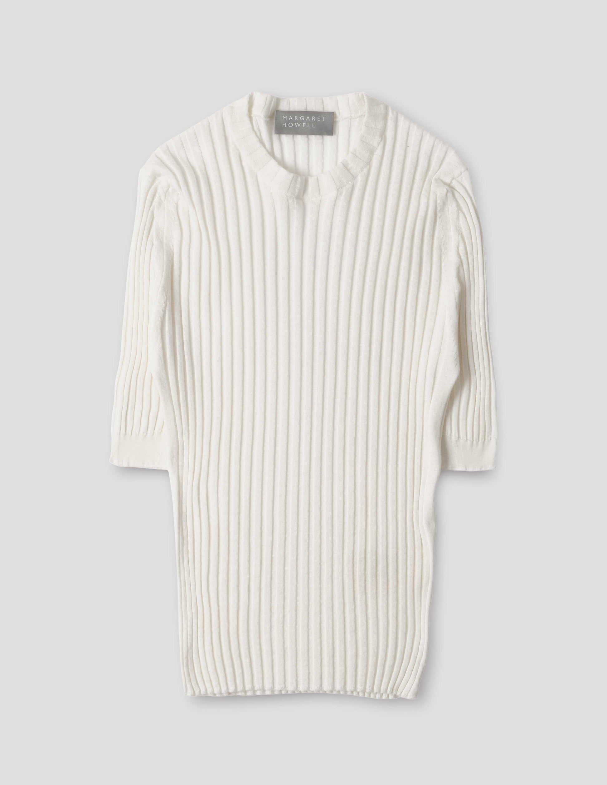 Beige knitted ribbed t-shirt with round neck and fine rib sleeve cuffs. Front flat lay view.