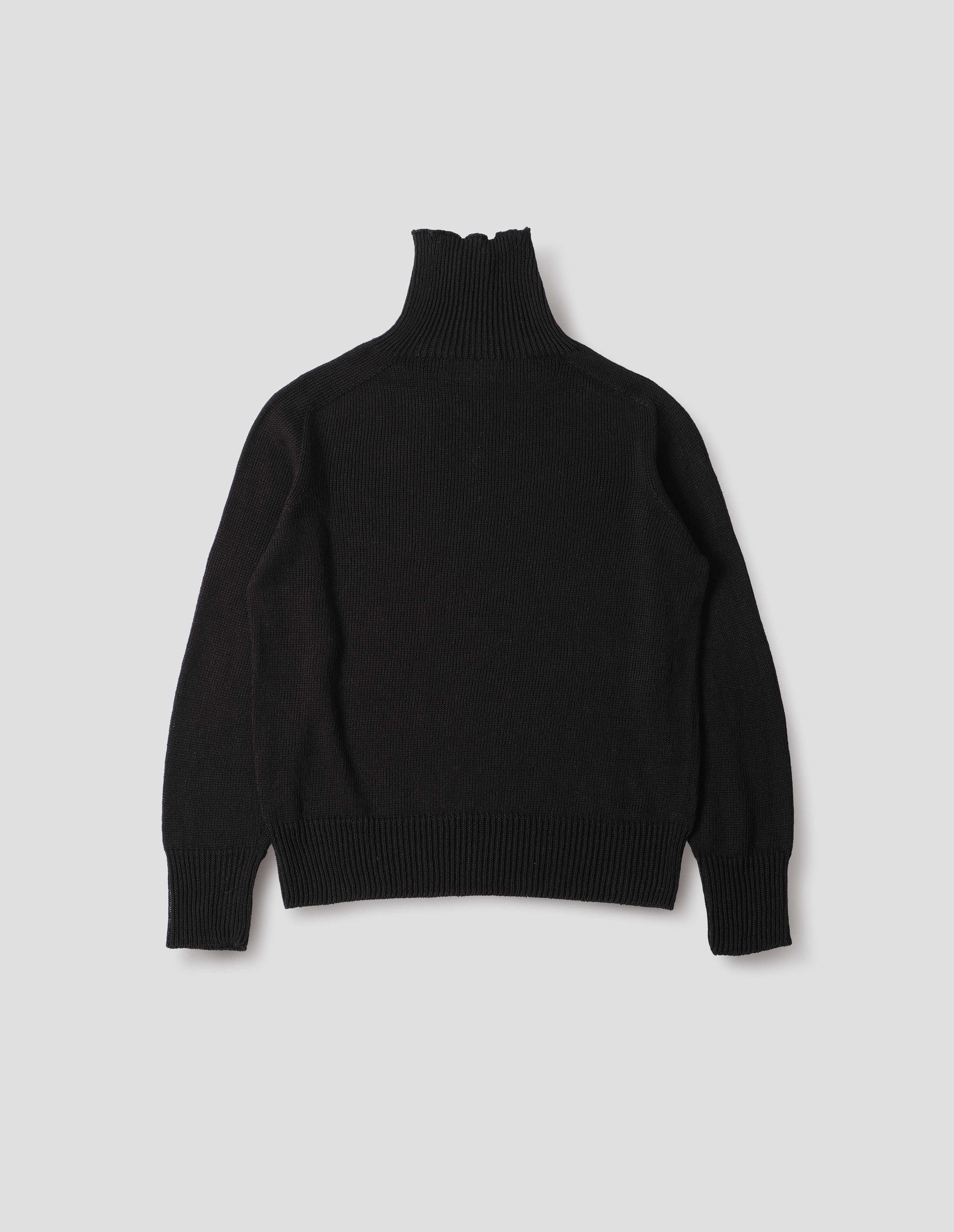 Black linen cotton roll neck jumper with long saddle sleeves and contrast rib on neck, cuffs and hem. Back flat lay view.