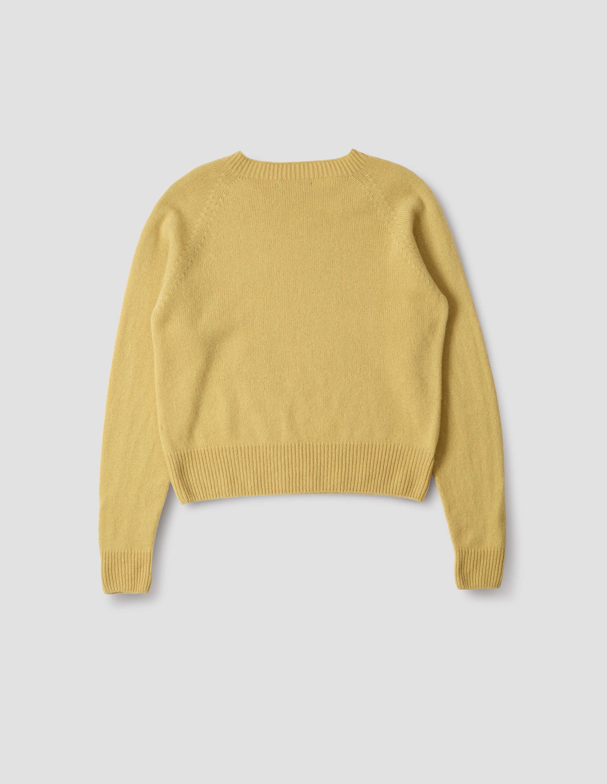 Yellow merino cashmere long sleeve jumper, with raglan sleeve and contrast rib on neck, cuffs and hem. Back flat lay view.
