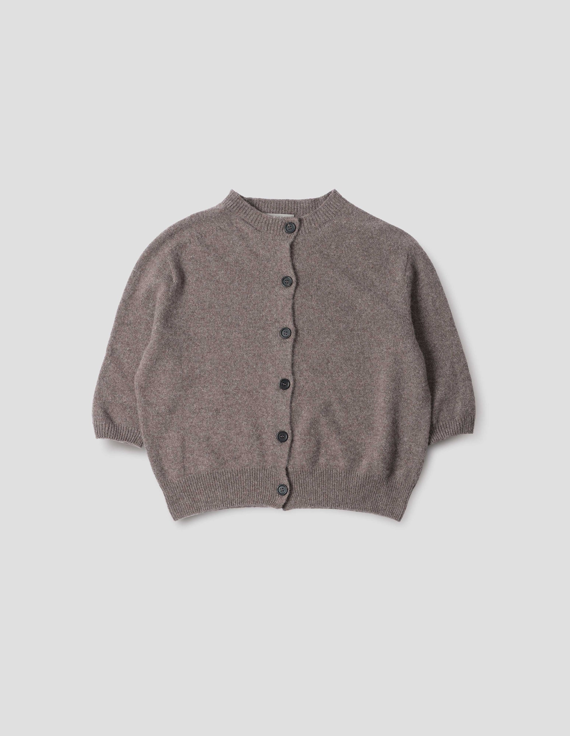 Greyish beige cashmere cotton cardigan, with elbow length saddle sleeve and large horn buttons. Front flat lay view.