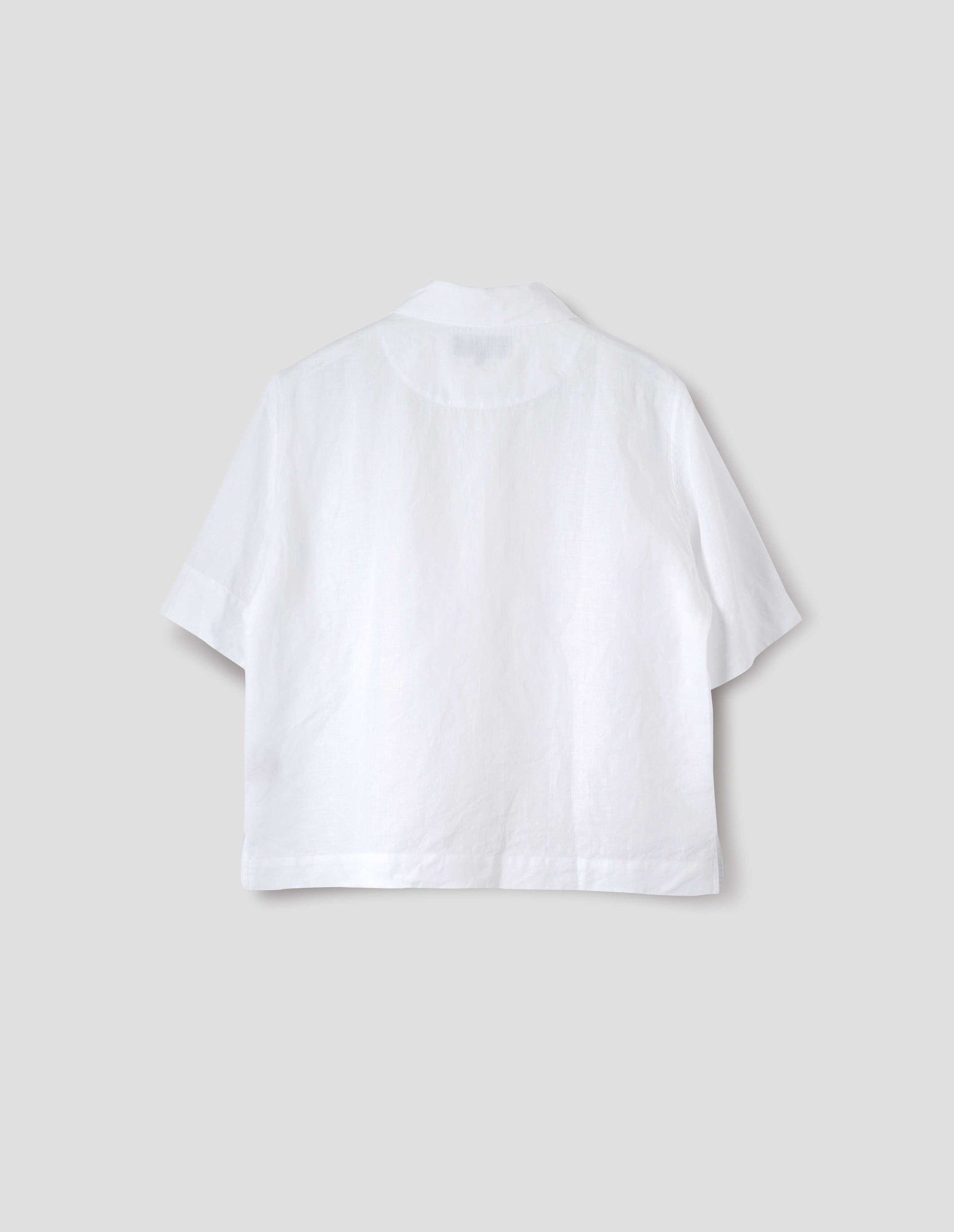 White linen short sleeve shirt, with side split hem. Back flat lay view.