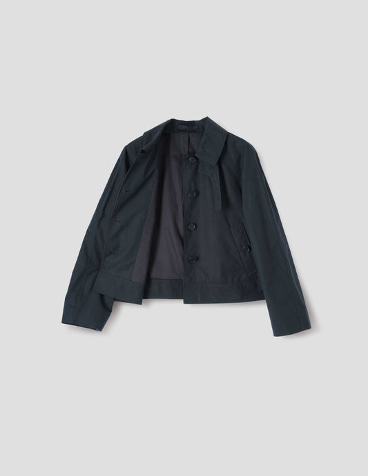 Black ventile cotton poplin long sleeve short trench, with horn button closure, slant side pockets, adjustable storm tab, black lining and hanger loop on collar, front flat lay open view. 