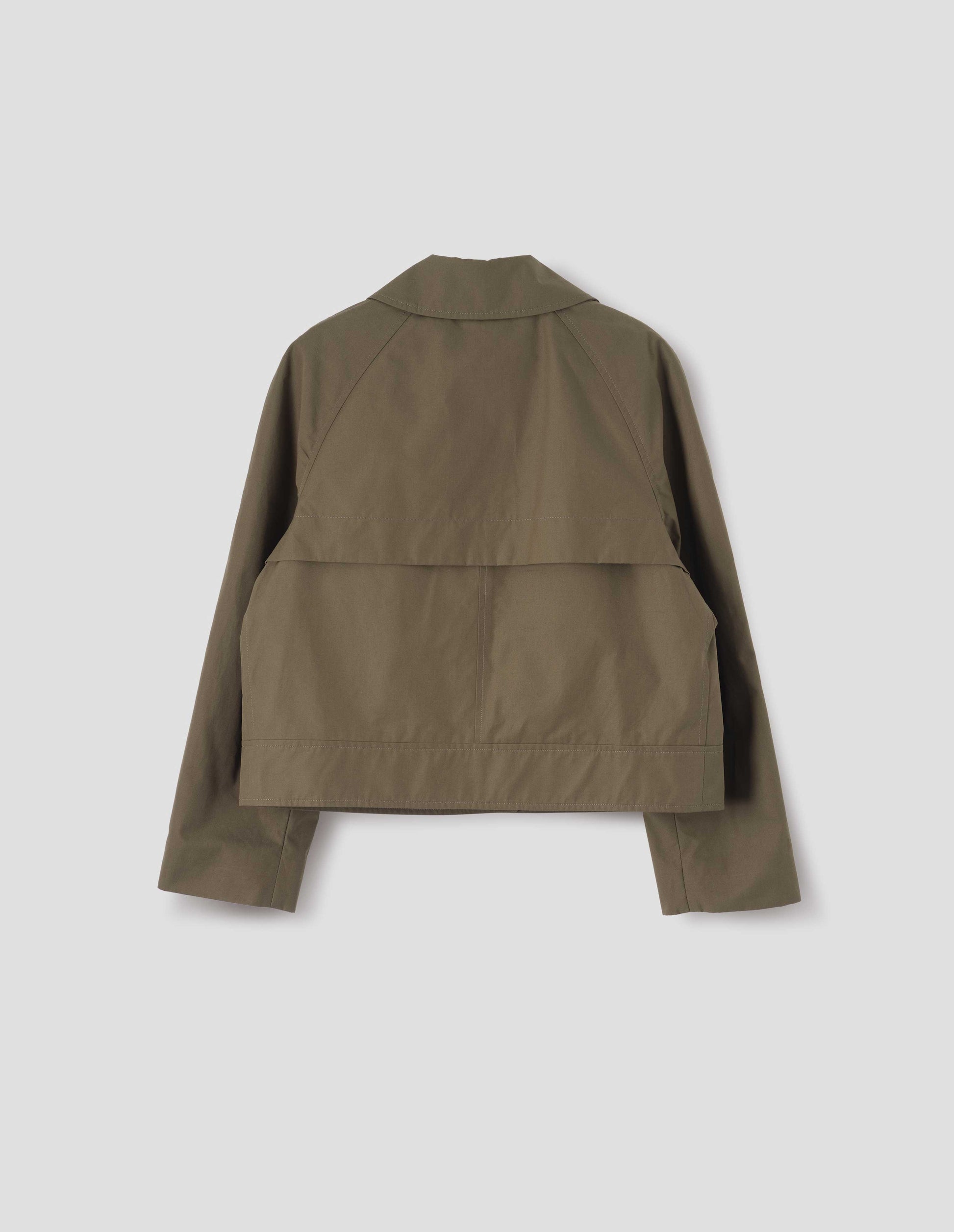 Greenish brown ventile cotton poplin long sleeve short trench, with storm vent. Back flat lay view.