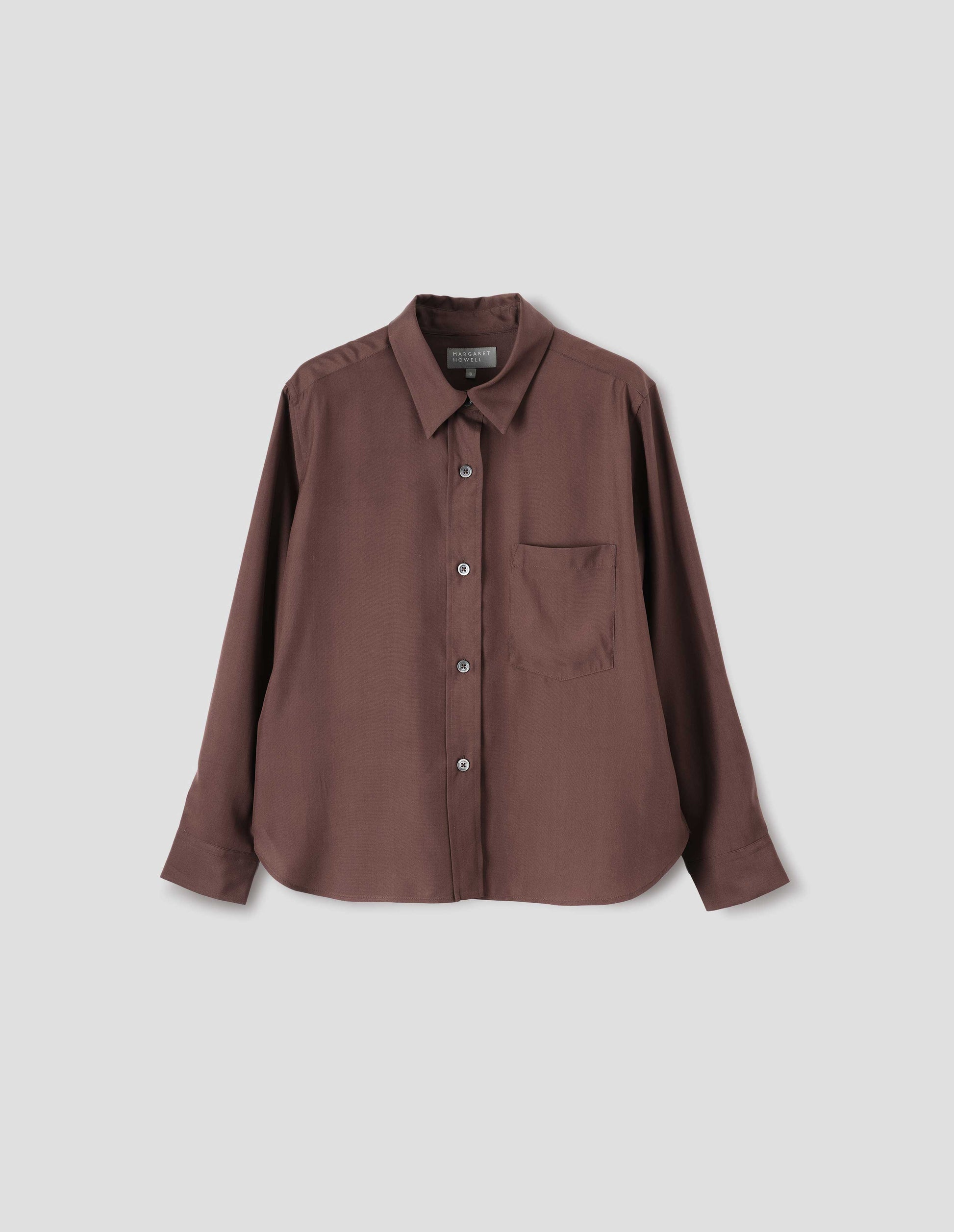 Brown shirt with raised placket and horn buttons, patch pocket on chest. Front flat lay view.