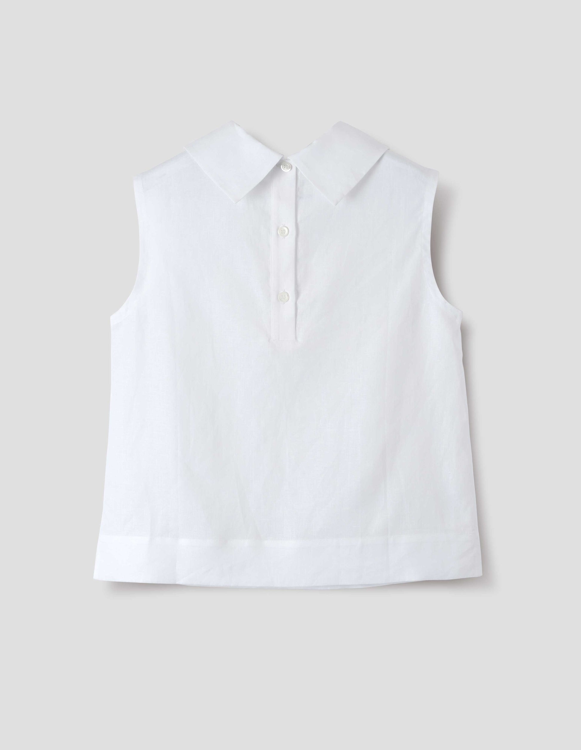 White regular cut Irish linen top with exaggerated collar, button-fastening placket at the centre back, with a deep hem with side splits. Back flat lay view.