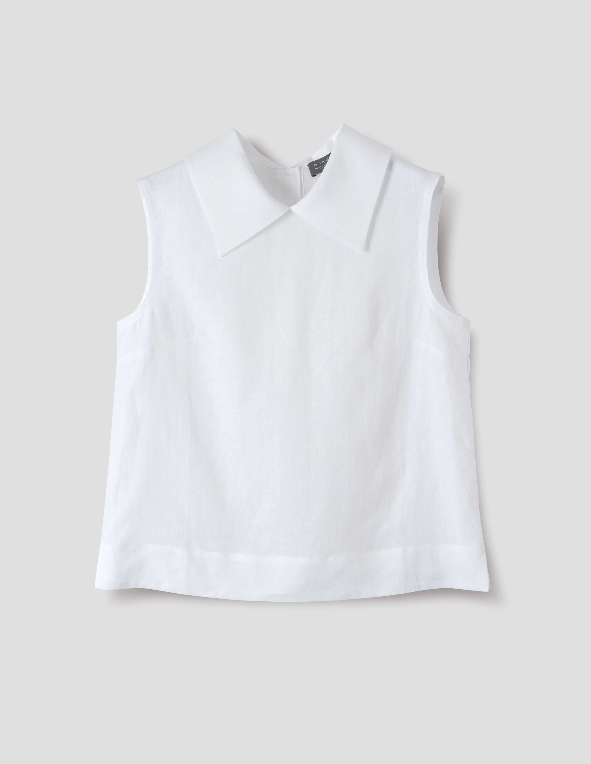 White regular cut Irish linen top with exaggerated collar, side dart detailing, with a deep hem with side splits. Front flat lay view.
