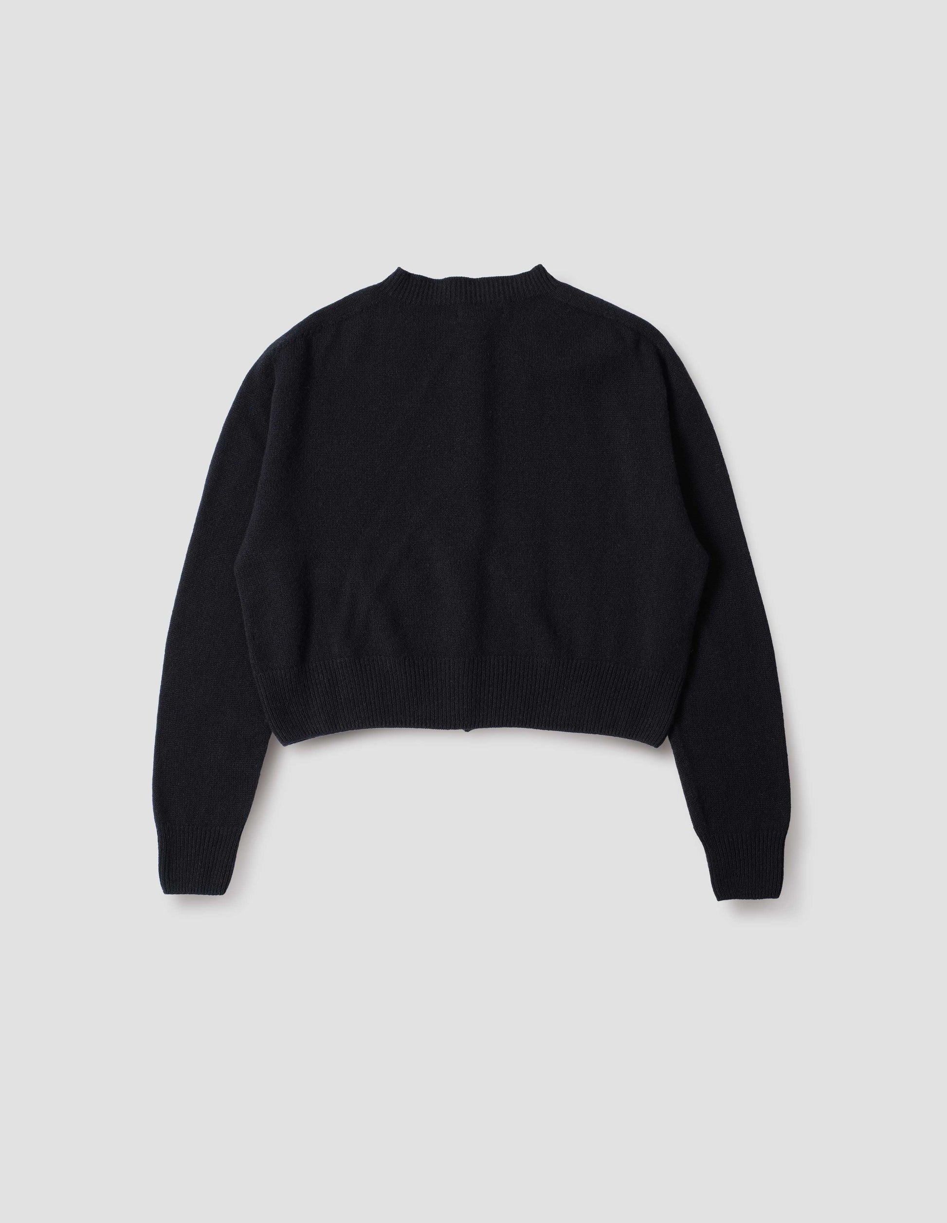 Dark navy  long sleeve merino cashmere cardigan with contrast rib neckline, cuffs and hem. Back flat lay view.