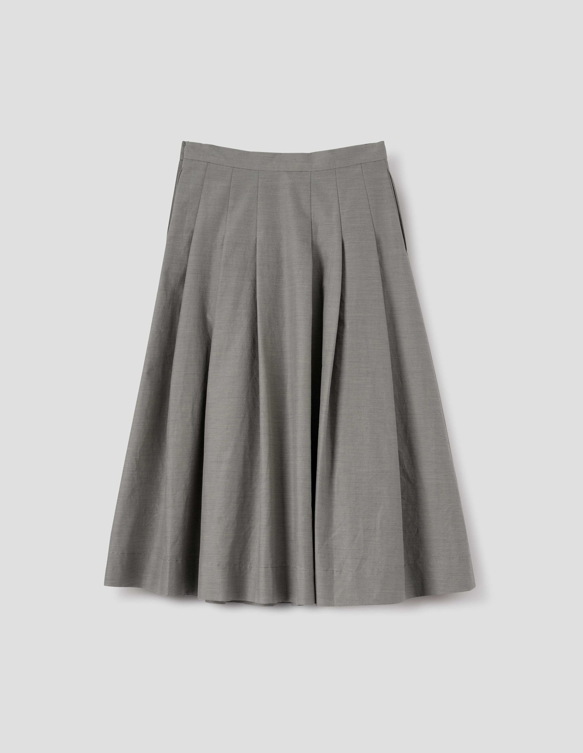 Black and cream stripe relaxed cut below knee skirt, minimal waistband, stitched down pleats, and concealed side seam pockets. Back flat lay view. 