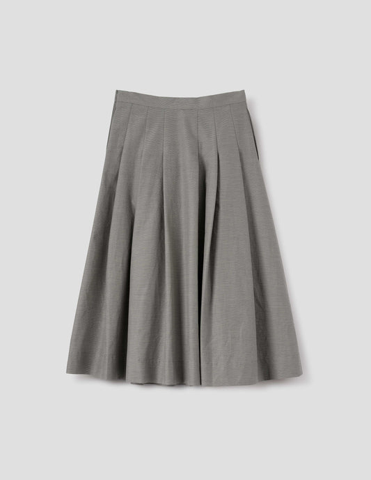 Black and cream stripe relaxed cut below knee skirt, minimal waistband, stitched down pleats, and concealed side seam pockets. Back flat lay view. 