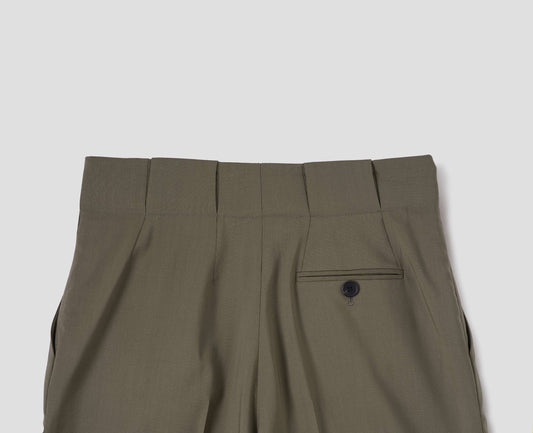 Brown wool trousers, grown-on waistband with large belt loops and a button-through jet back pocket and horn button. Back flat lay view.