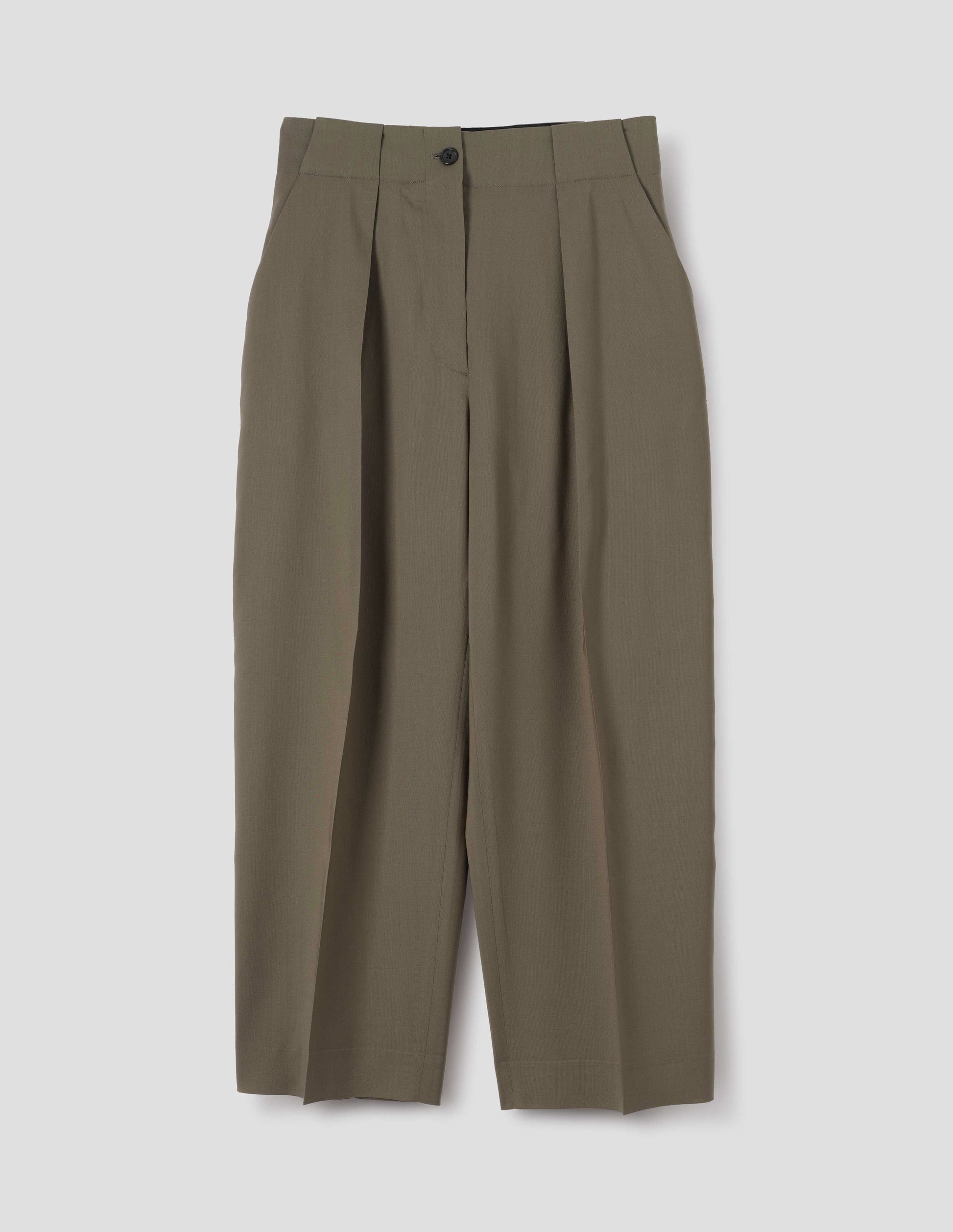 Brown wool trousers, single pleats and grown-on waistband with large belt loops and horn button. Front flat lay view.