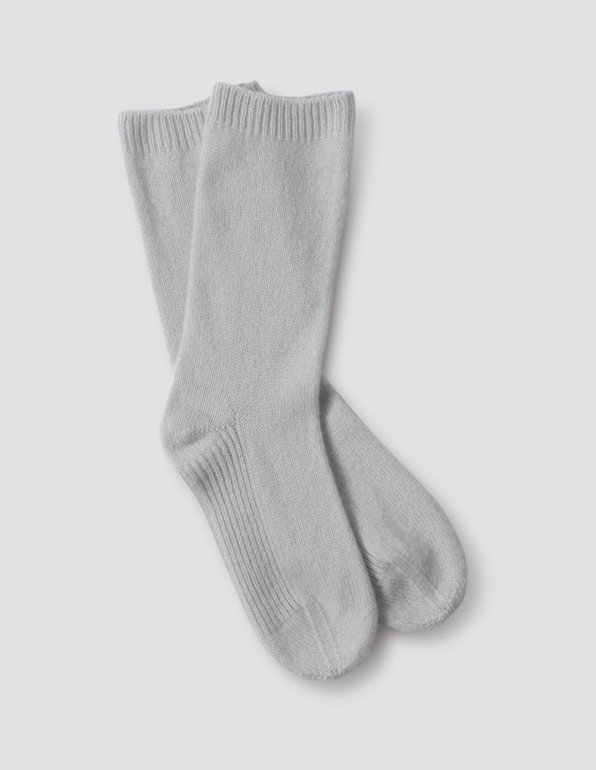 Light grey merino wool and cashmere bed socks, front flat lay view.