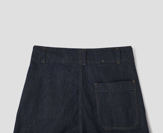 Indigo blue wide leg light denim twill jean, with slant side pockets, patch back pocket and belt loops. Back flat lay view.