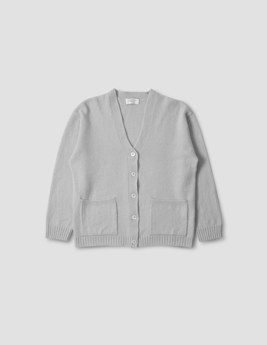 Light grey merino cashmere bed cardigan, with contrast rib on neck, cuff and hem and front patch pockets. Front flat lay view.