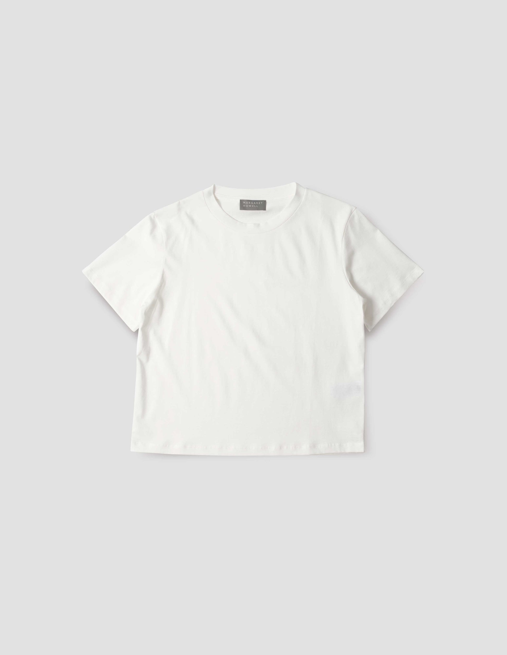 Off white cotton short sleeve t-shirt with boxy cut, front flat lay view.