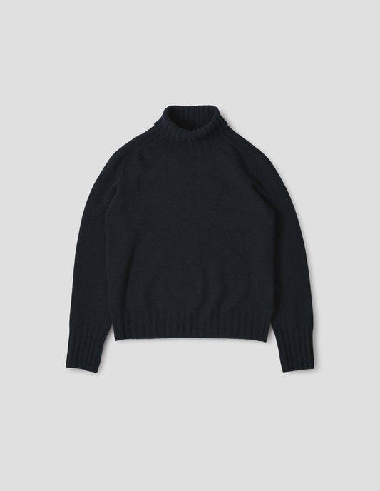 Dark navy blue cashmere roll neck jumper with contrast ribbing on neck, cuffs and hem. Front flat lay view.